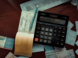 A calculator sitting on top of a wooden table