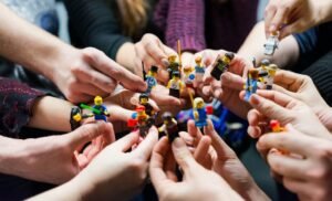 People holding miniature figures