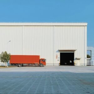Red freight truck beside building