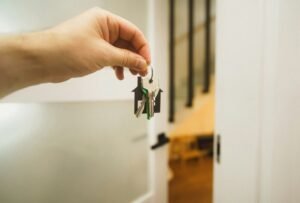 A hand holding a key to a door