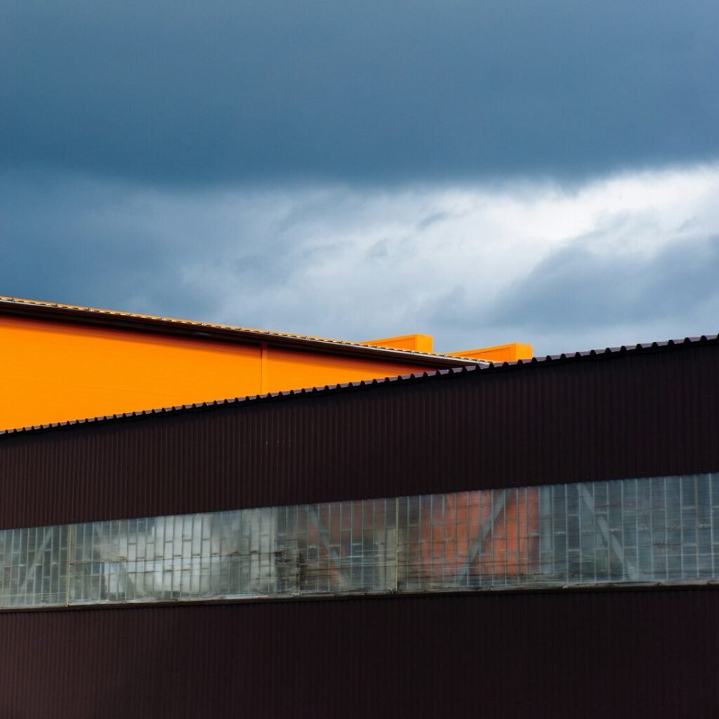 Orange roof and dark building under a stormy sky