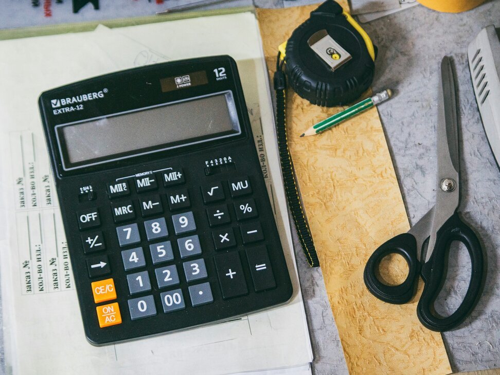 Calculator and office supplies on a desk