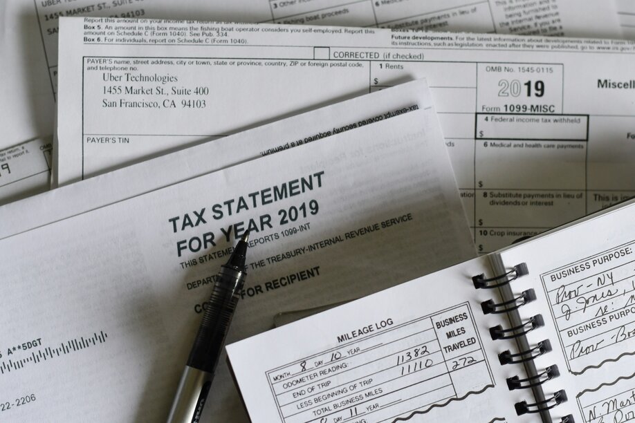 Tax statement, notebook and pen on a desk