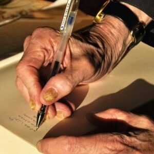 Person holding black click pen