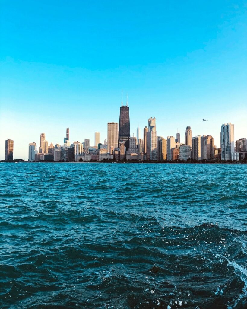 The Chicago skyline across Lake Michigan with choppy blue water in the foreground