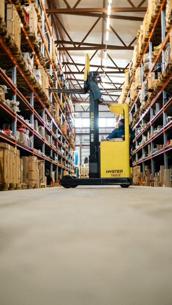 A yellow forklift in a large warehouse