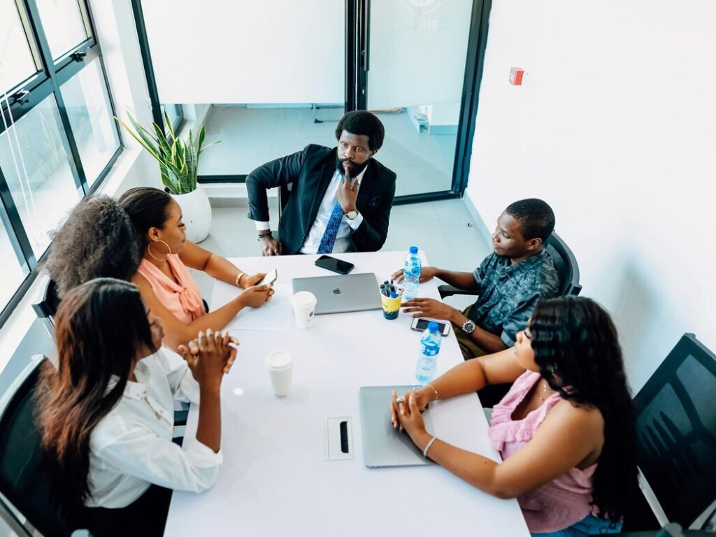 A group of people sitting around a white table