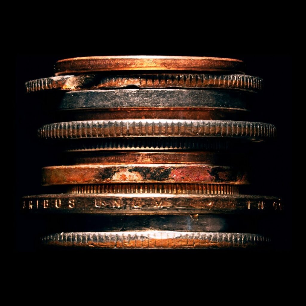 Stack of copper coins against black background