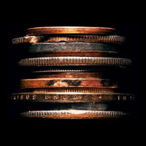 Stack of copper coins against black background