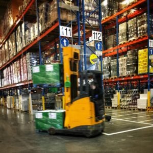 A forklift driving through a warehouse filled with pallets