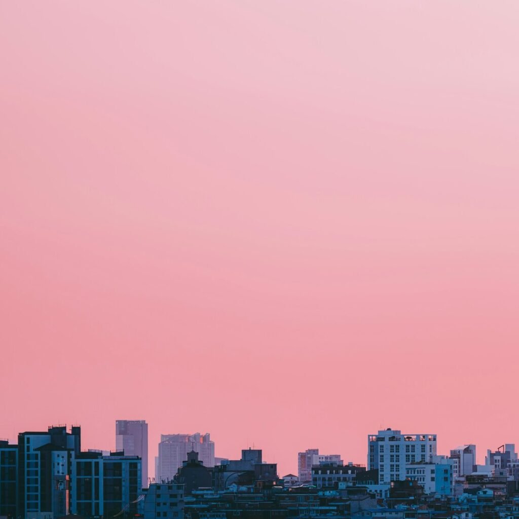 City skyline under a soft pink sky