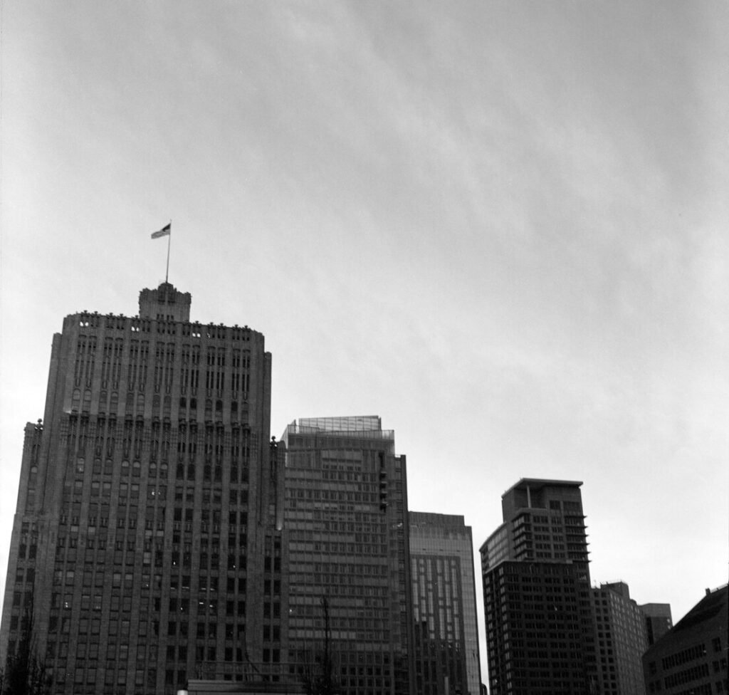 A black and white photo of a city with tall buildings