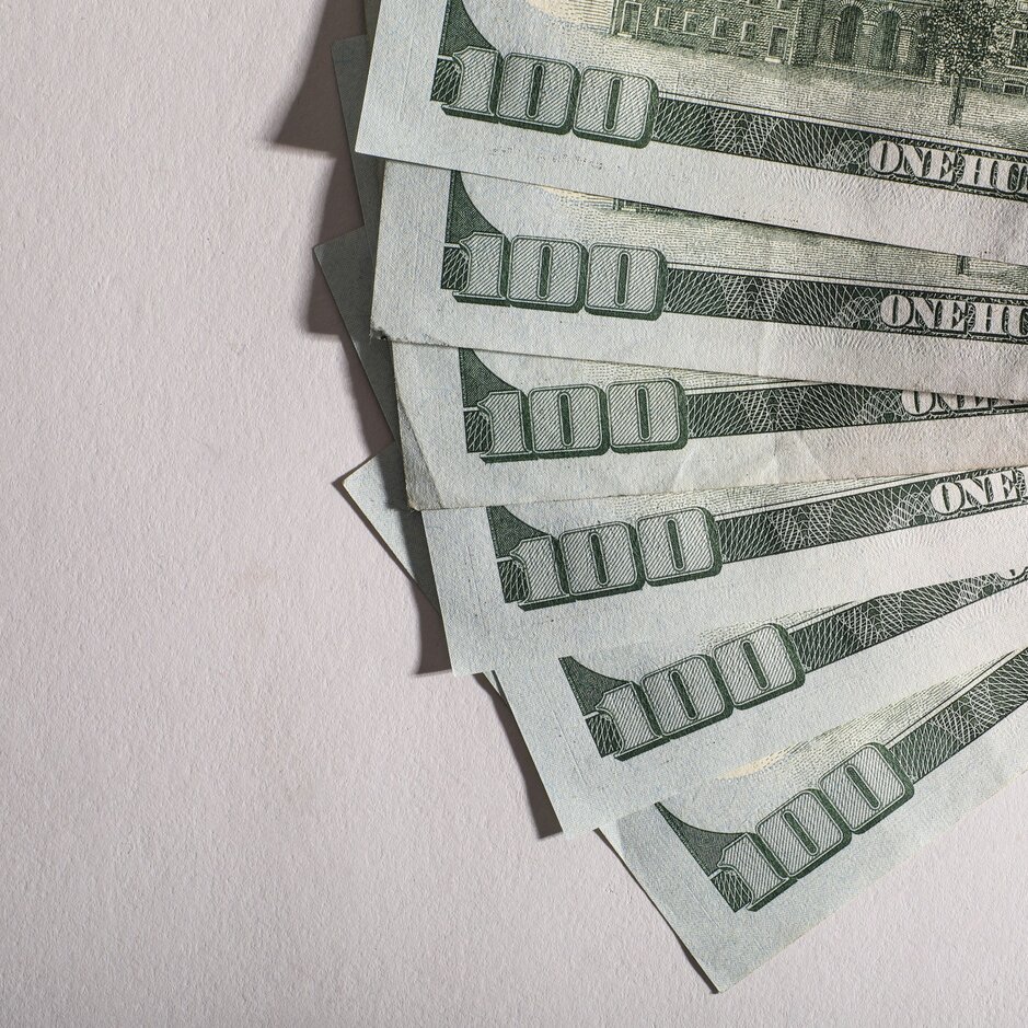 Several one hundred dollar bills fanned out