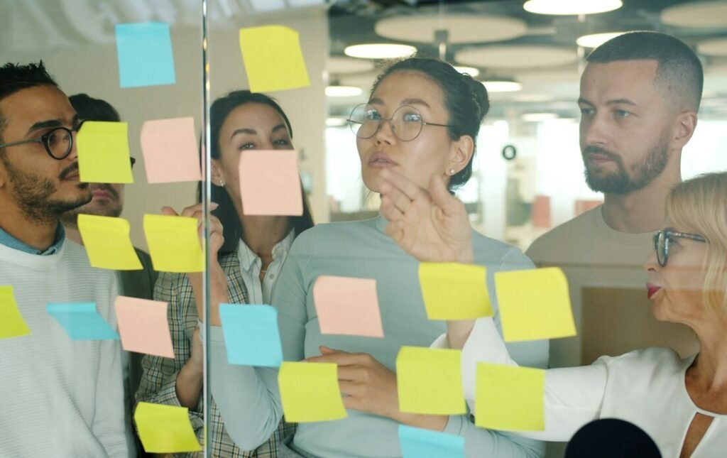 Diverse team collaborating on sticky notes