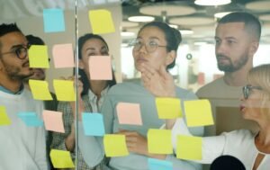 Diverse team collaborating on sticky notes