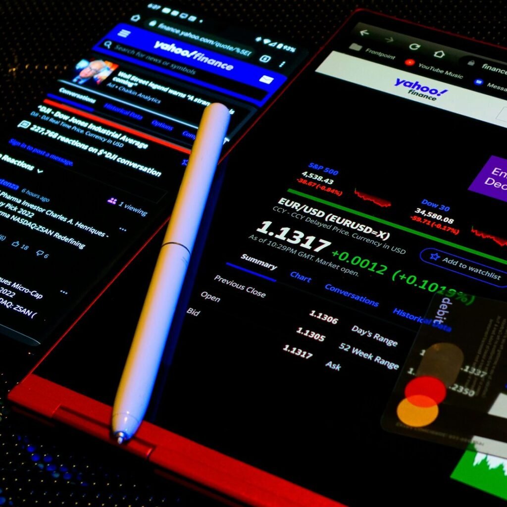 A cell phone with a pen on top of it