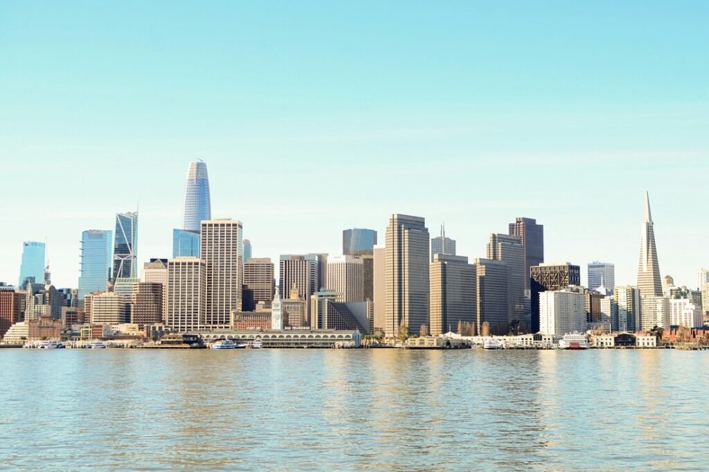City skyline across body of water during daytime