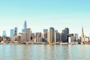 City skyline across body of water during daytime