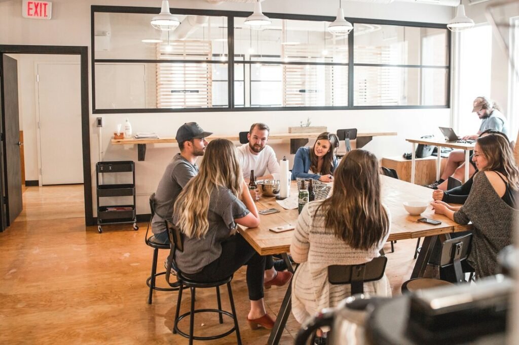 Talking people sitting beside table