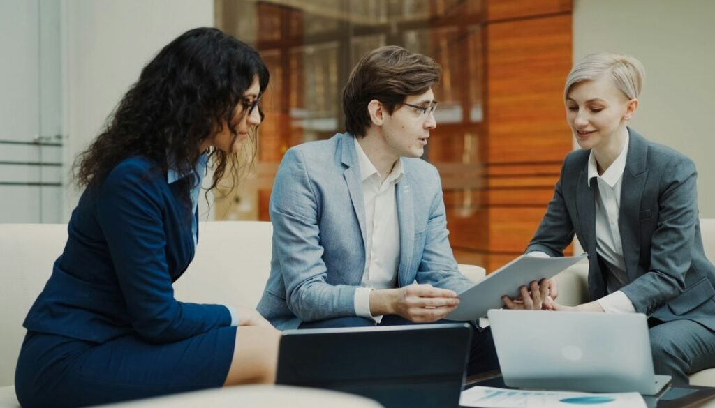 Three professionals discussing documents at a table