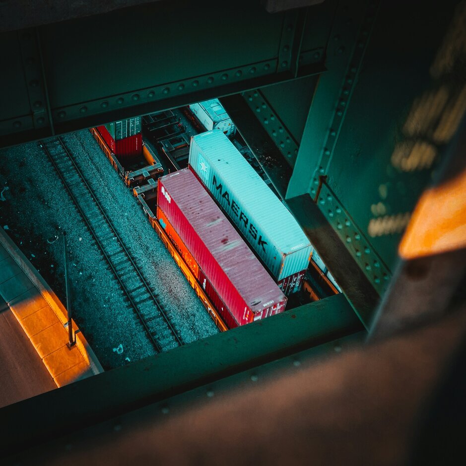 A train traveling down train tracks next to a train station