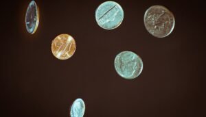 Silver round coins on white surface