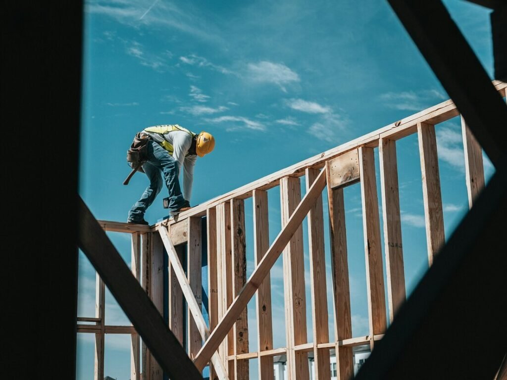 Construction worker in hard hat on building frame