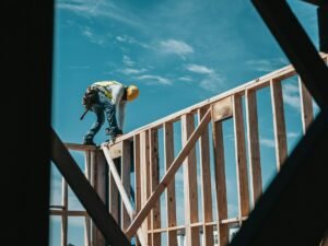 Construction worker in hard hat on building frame