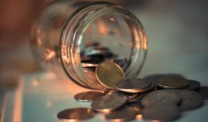 Clear glass jar with coins