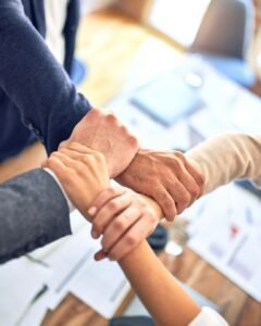 Team members gripping wrists in unity gesture