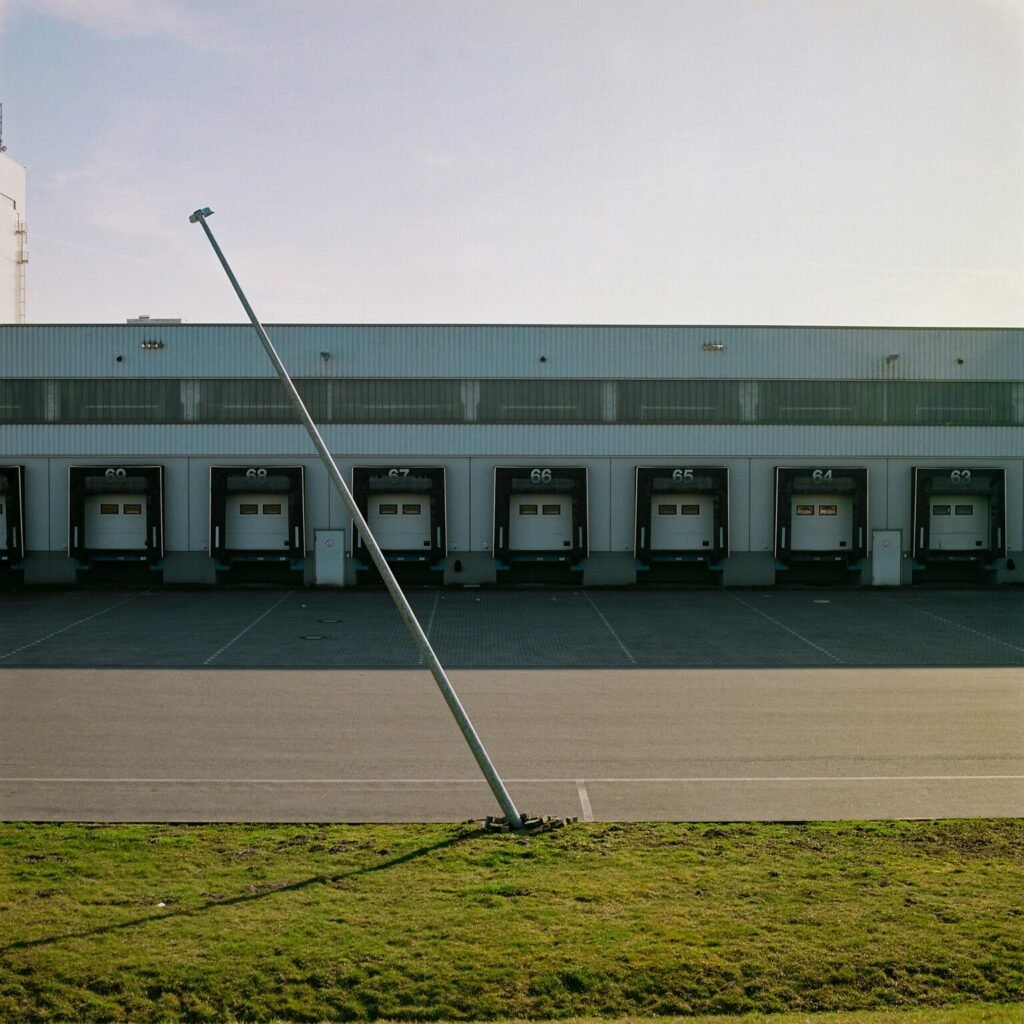 White and gray building with green grass field