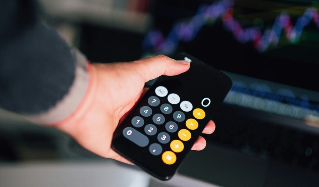 A person holding a remote control in their hand