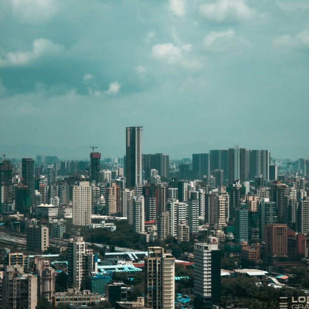 A sprawling cityscape with tall buildings under a cloudy sky