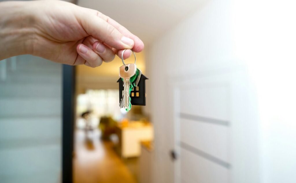 Holding house keys in front of the entrance