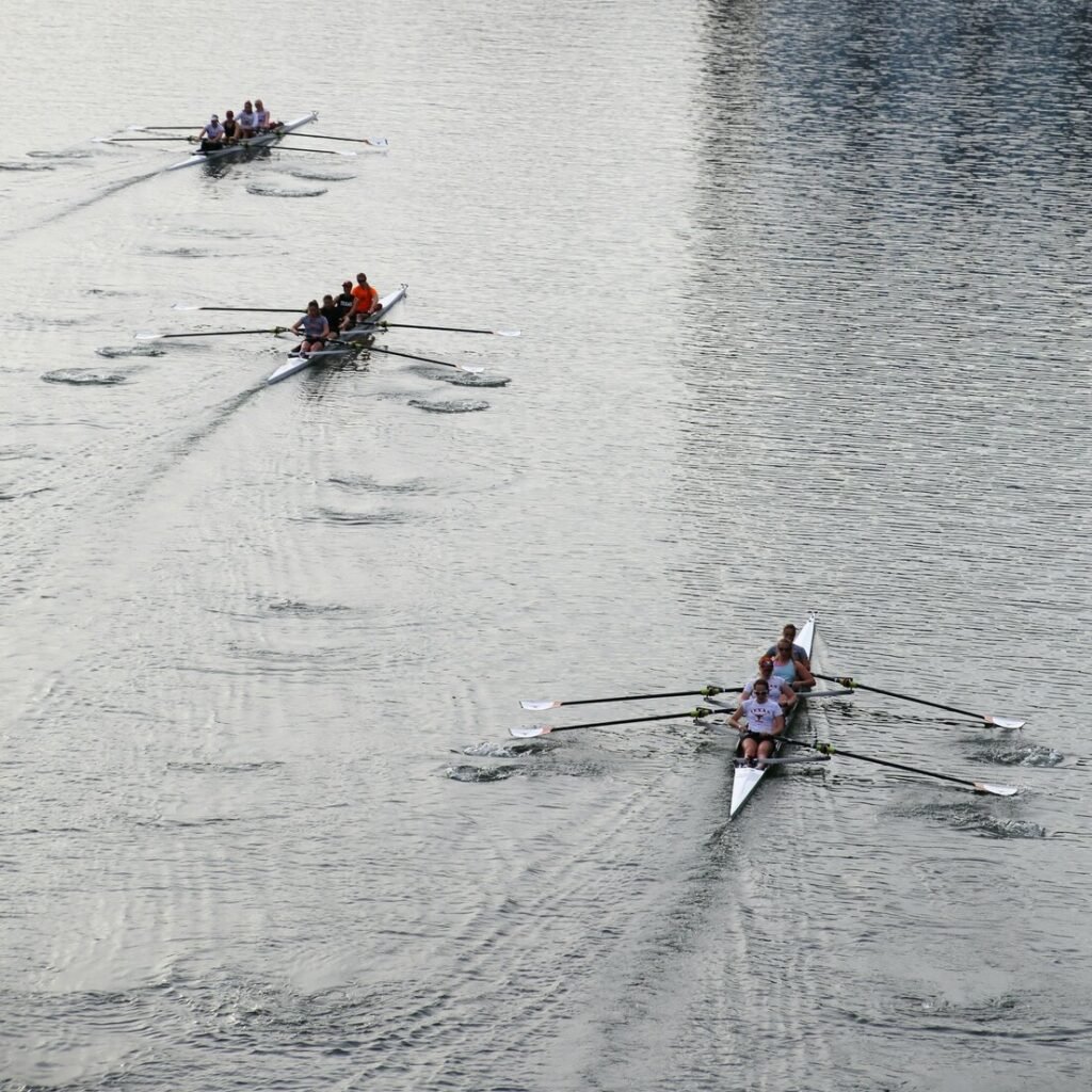 A group of people rowing on a body of water