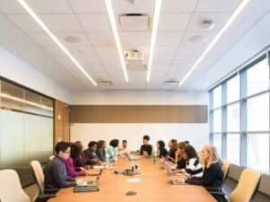 People having meeting on rectangular brown table