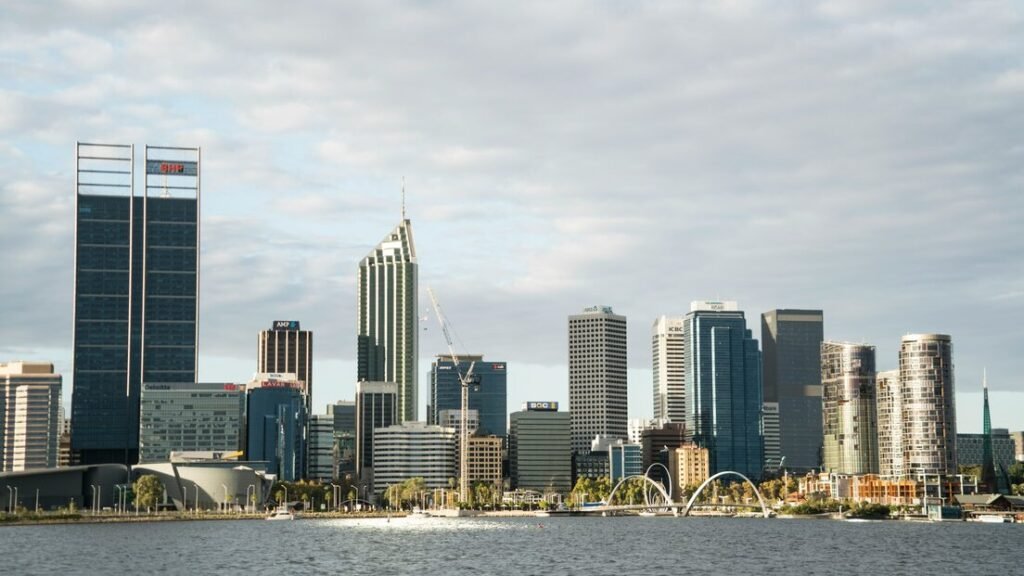 White and blue city buildings near body of water during daytime