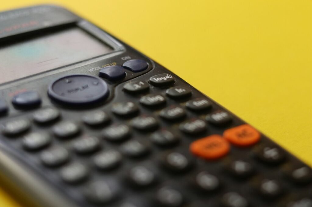 Black remote control on yellow surface