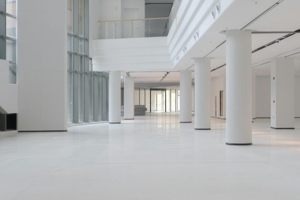 Modern white interior with large columns and windows