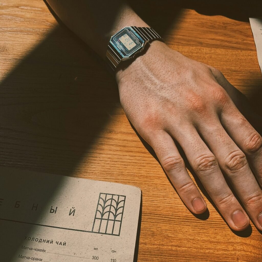 Person wearing black and blue smart watch