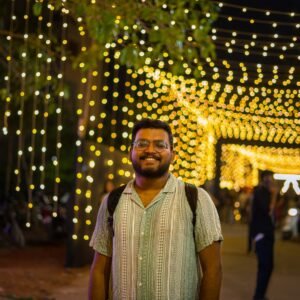 A man standing in front of a tunnel of lights