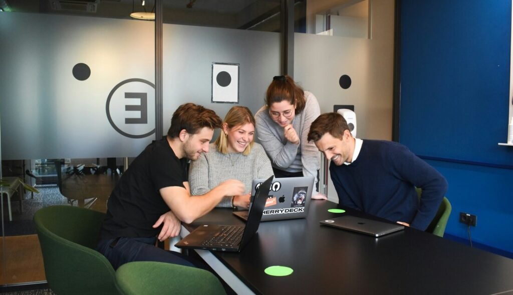 People sitting on chair in front of laptop computers