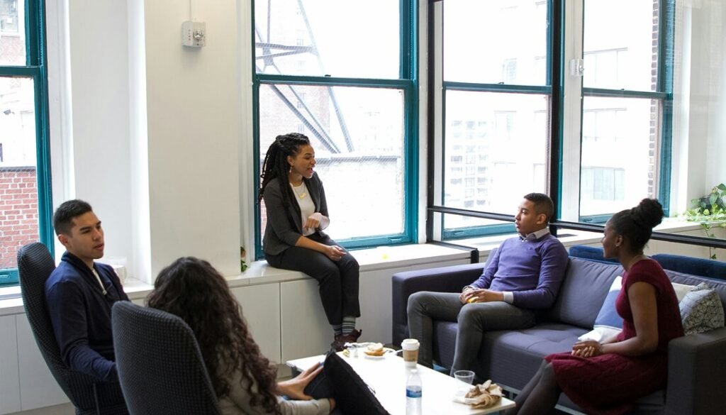 A group of people sitting around a living room