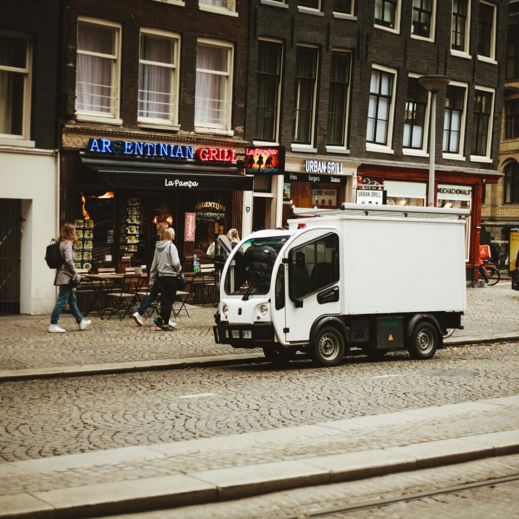 White box truck by building