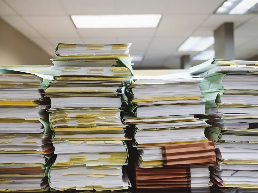 Tall stacks of paper files in an office