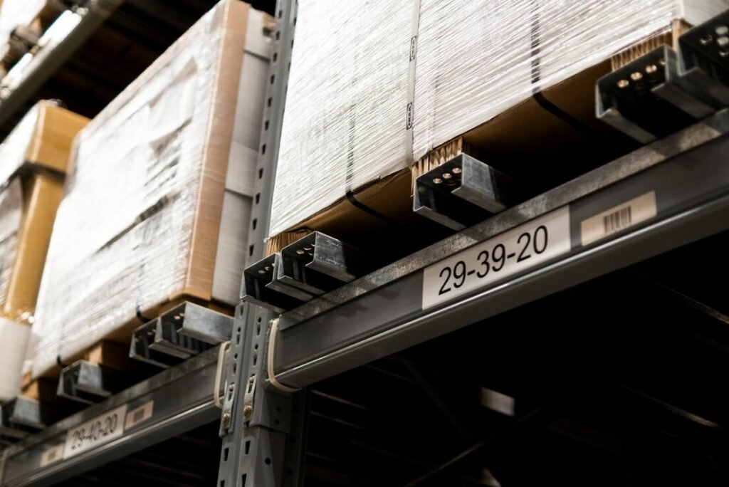 A close up of a metal shelf with boxes on it