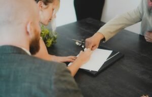 Couple signing document at desk