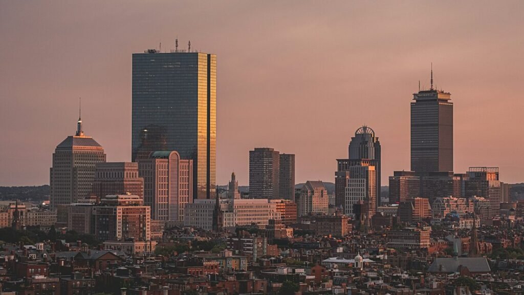 Aerial view of city under cloudy sky during daytime