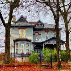 House near trees and fence during daytime
