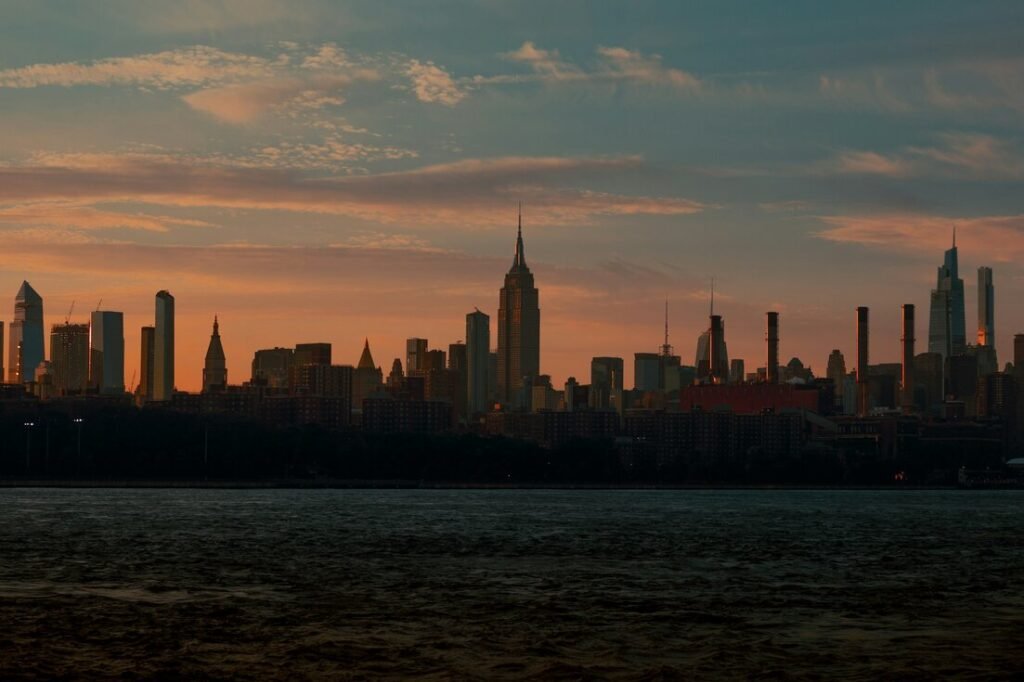 A city skyline with a body of water in the foreground